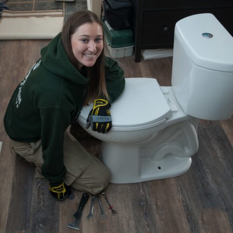 Corpsmember installing a high efficiency toilet
