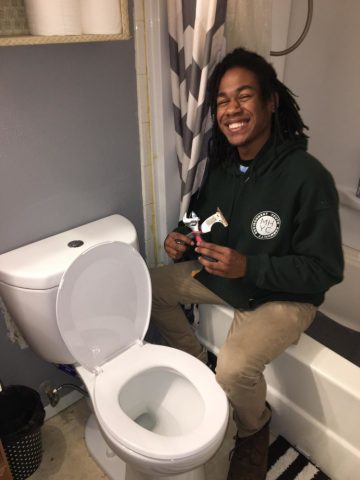 Corpsmember installing a high efficiency toilet