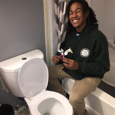 Corpsmember installing a high efficiency toilet