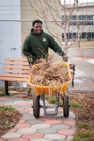 Corpsmember hauling yard waste.