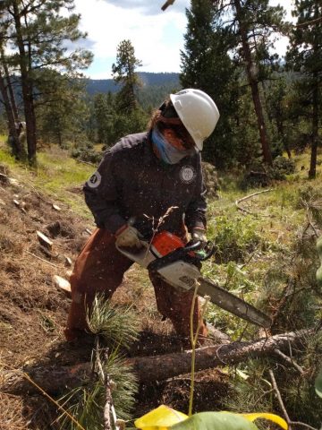 Corpsmember cutting lumber.