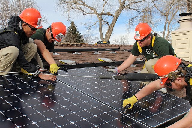 MHYC Construction crew members working on solar panel installation.